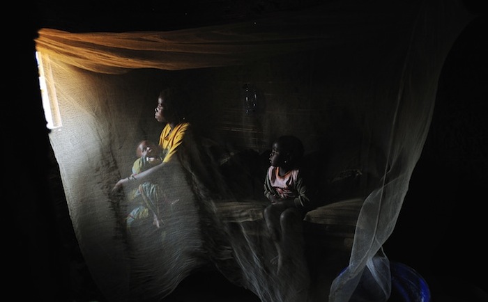A woman named Kahindo, 20, sits at home with her two children born of rape in North Kivu, eastern Congo. Six Interahamwe soldiers kidnapped and forcibly held her in he bush for almost three years. Photo Credit: (Lynsey Addario/VII)